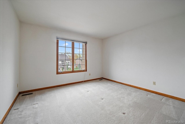 unfurnished room with carpet floors and baseboards