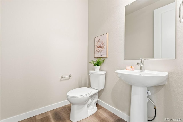 9700 E 63rd Pl, Denver, CO 80238 - half bath featuring toilet, wood finished floors, and baseboards