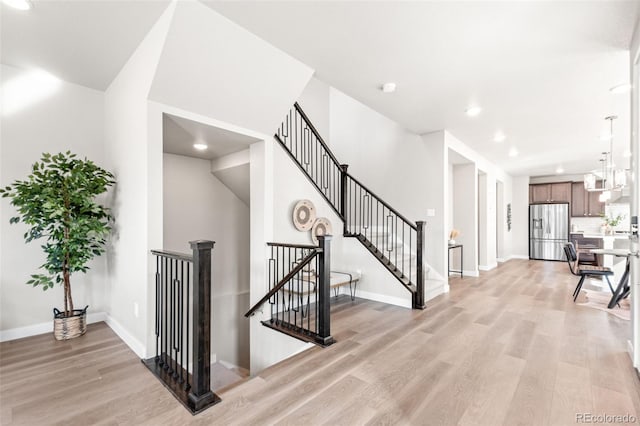 9700 E 63rd Pl, Denver, CO 80238 - stairway featuring wood finished floors, baseboards, and recessed lighting
