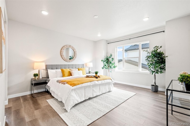 9700 E 63rd Pl, Denver, CO 80238 - bedroom featuring baseboards, wood finished floors, and recessed lighting