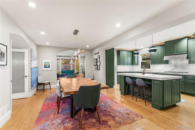 dining area featuring baseboards, a healthy amount of sunlight, and light wood-style floors