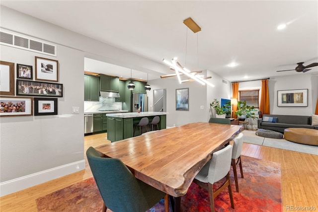 dining space with light wood-style floors, recessed lighting, visible vents, and baseboards