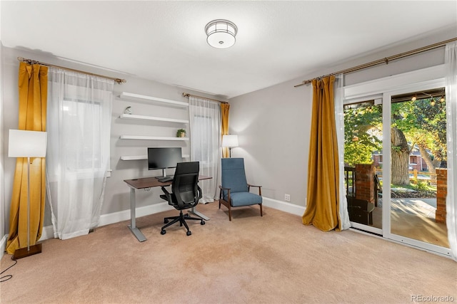 carpeted home office with baseboards