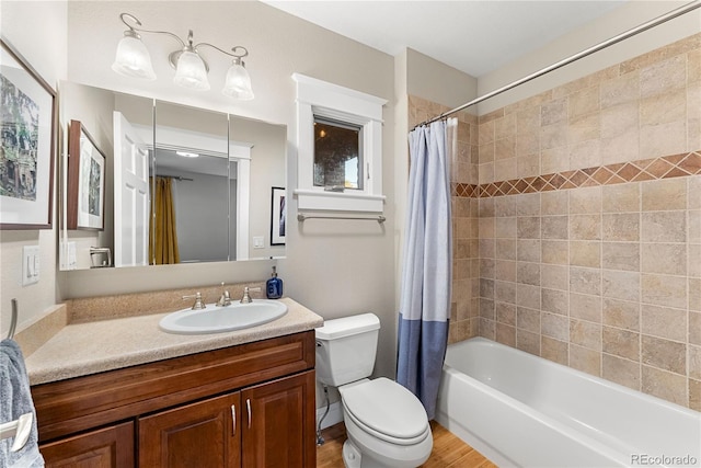 bathroom featuring shower / tub combo with curtain, vanity, toilet, and wood finished floors