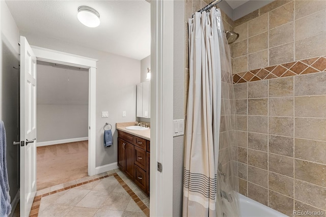 full bath featuring tile patterned floors, baseboards, shower / bath combination with curtain, and vanity