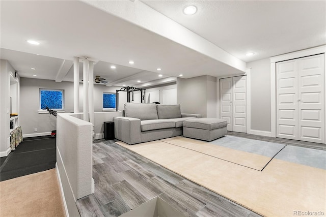 living room with baseboards, wood finished floors, and recessed lighting