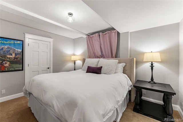 bedroom with carpet floors and baseboards