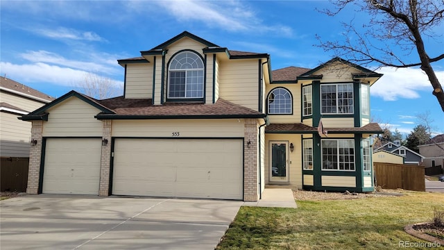 view of front property with a garage and a front yard