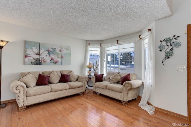 living room featuring hardwood / wood-style flooring and a textured ceiling