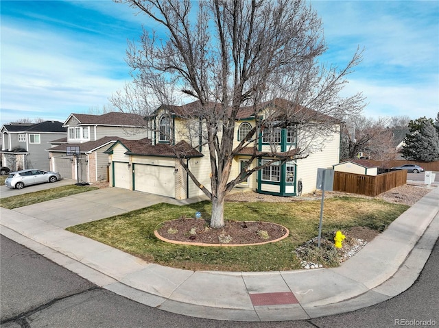 view of front property featuring a garage and a front lawn