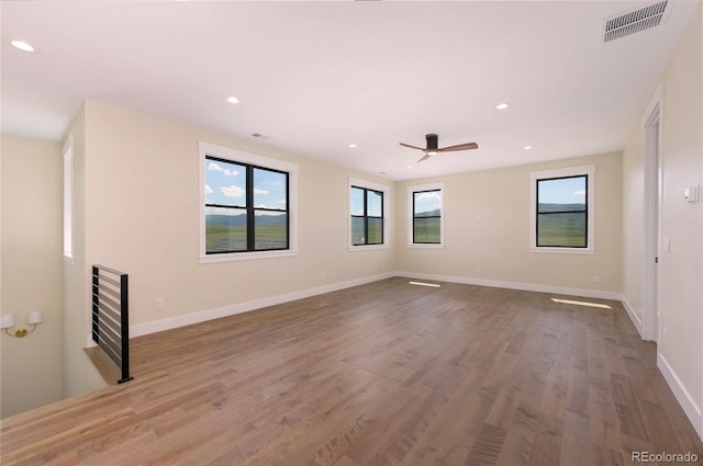 unfurnished room with wood-type flooring and ceiling fan