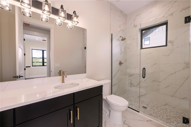 bathroom with vanity, an enclosed shower, and toilet