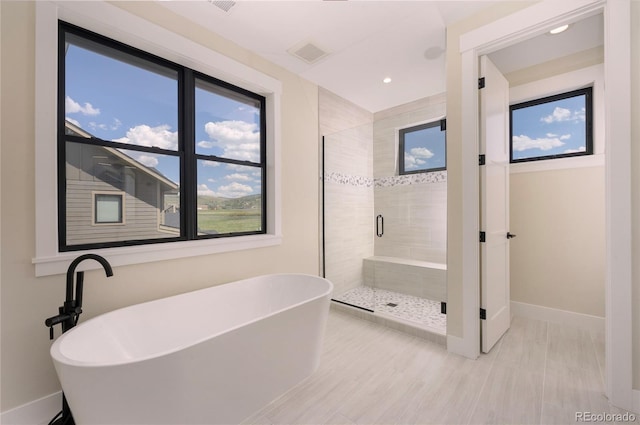 bathroom with separate shower and tub