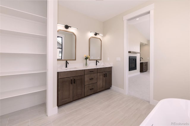 bathroom with vanity and a bath