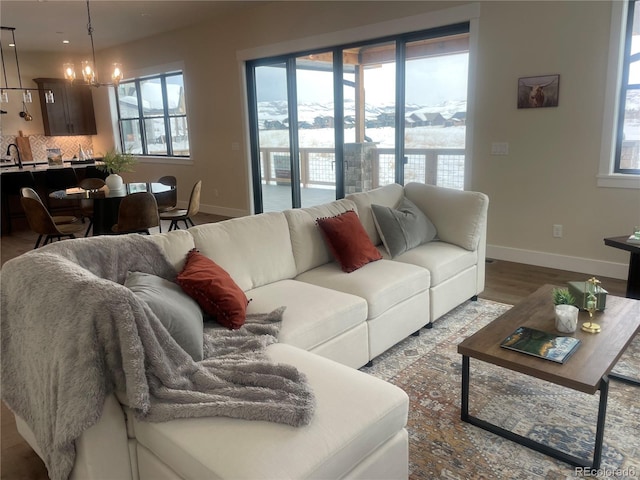 living room featuring hardwood / wood-style flooring and a chandelier