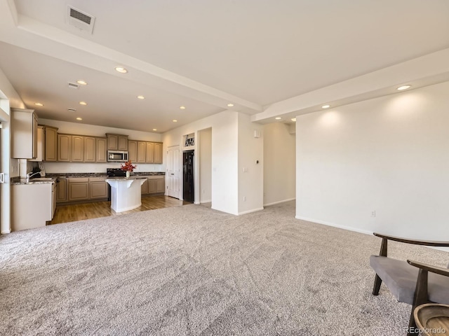 unfurnished living room featuring light carpet, baseboards, visible vents, and recessed lighting