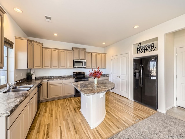 kitchen with a center island, recessed lighting, light wood-style flooring, a sink, and black appliances