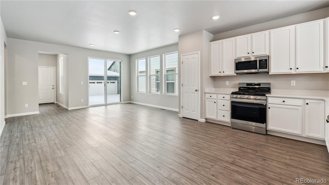 kitchen featuring white cabinetry, appliances with stainless steel finishes, and light wood-type flooring