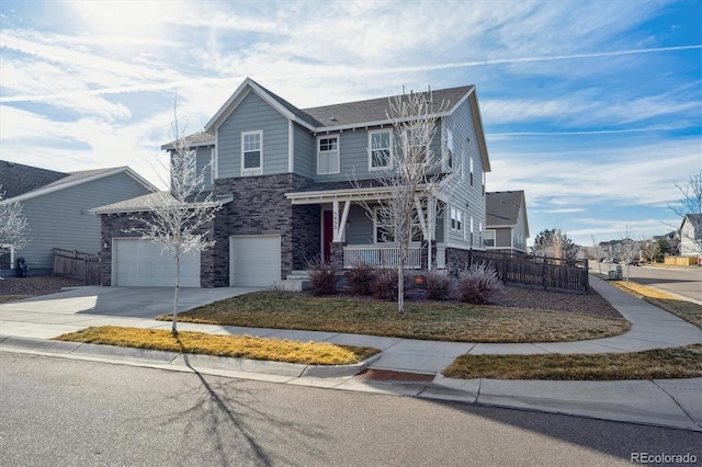 view of property with a porch, a garage, and a front yard