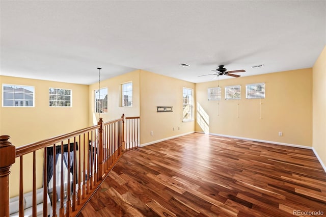 1929 Baguette Dr, Castle Rock, CO 80108 - unfurnished room featuring wood finished floors, healthy amount of natural light, ceiling fan, and baseboards