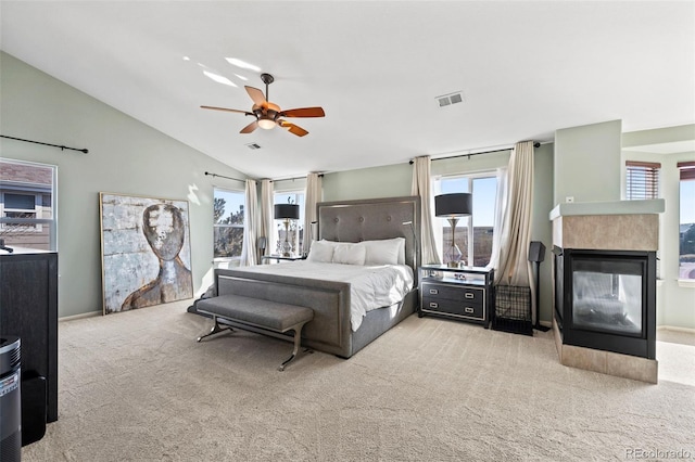 1929 Baguette Dr, Castle Rock, CO 80108 - bedroom with vaulted ceiling, carpet flooring, a multi sided fireplace, and ceiling fan
