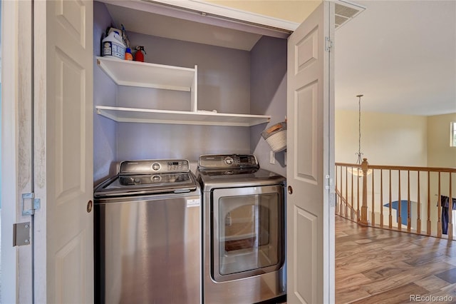 1929 Baguette Dr, Castle Rock, CO 80108 - laundry area with washing machine and dryer and wood finished floors