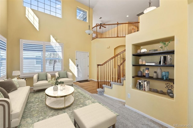 1929 Baguette Dr, Castle Rock, CO 80108 - living room with a high ceiling, stairway, plenty of natural light, baseboards, and carpet