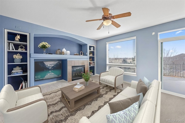 1929 Baguette Dr, Castle Rock, CO 80108 - carpeted living room featuring built in features, ceiling fan, baseboards, and a tiled fireplace