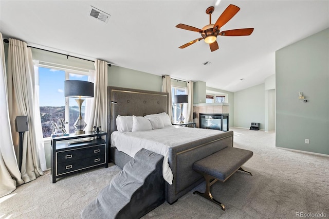 1929 Baguette Dr, Castle Rock, CO 80108 - carpeted bedroom with vaulted ceiling, multiple windows, a tiled fireplace, and ceiling fan