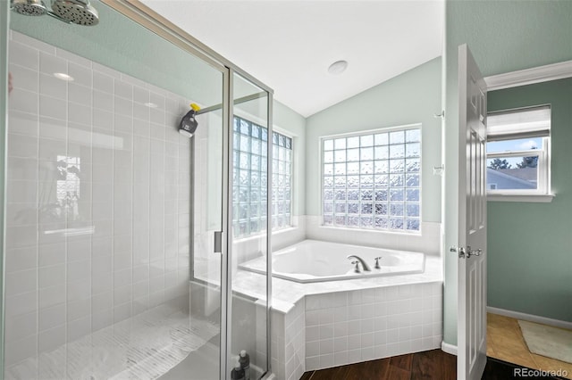 1929 Baguette Dr, Castle Rock, CO 80108 - bathroom with a stall shower, a bath, lofted ceiling, and wood finished floors