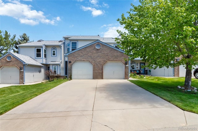 9155 W Portland Ave, Littleton, CO 80128 - view of front of house with brick siding, an attached garage, a front yard, and concrete driveway