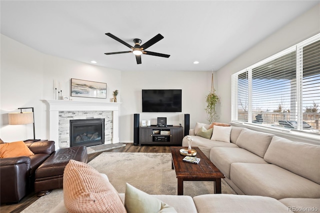 living area featuring dark wood-style floors, ceiling fan, a fireplace, and recessed lighting