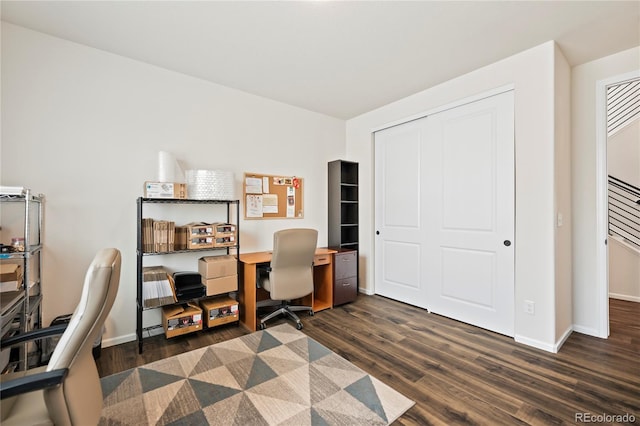 office space with dark wood-style floors and baseboards