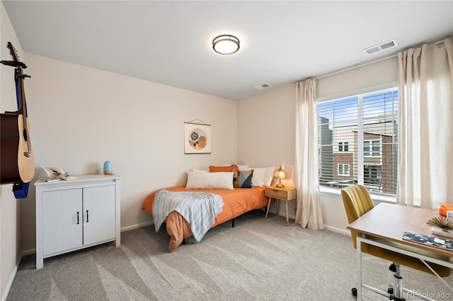 carpeted bedroom with visible vents and baseboards