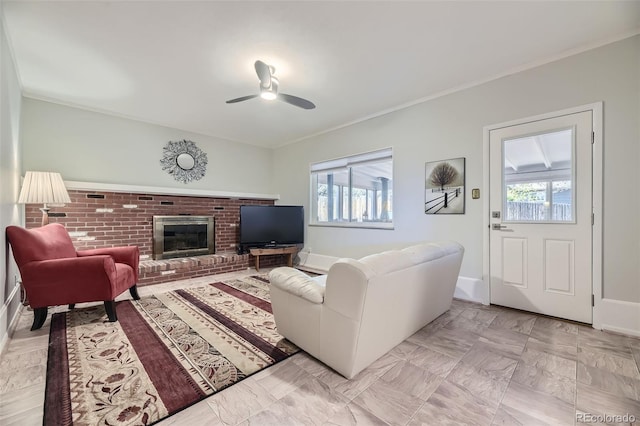 living room featuring a fireplace, ceiling fan, a healthy amount of sunlight, and crown molding