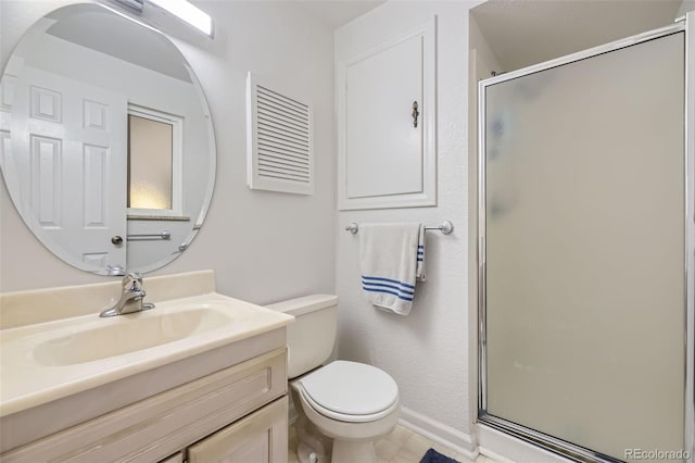 bathroom with vanity, toilet, and a shower with shower door