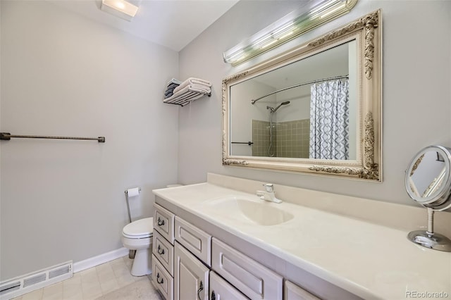 bathroom featuring toilet, vanity, and walk in shower