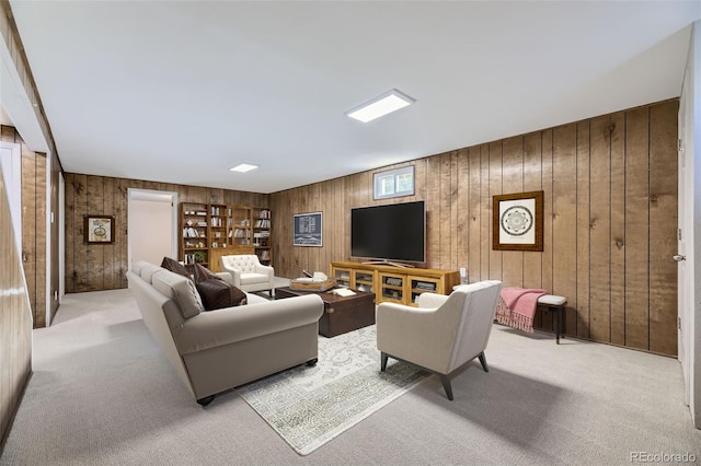 carpeted living room with wood walls