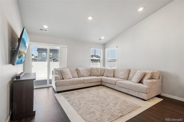 living room with lofted ceiling and dark hardwood / wood-style floors