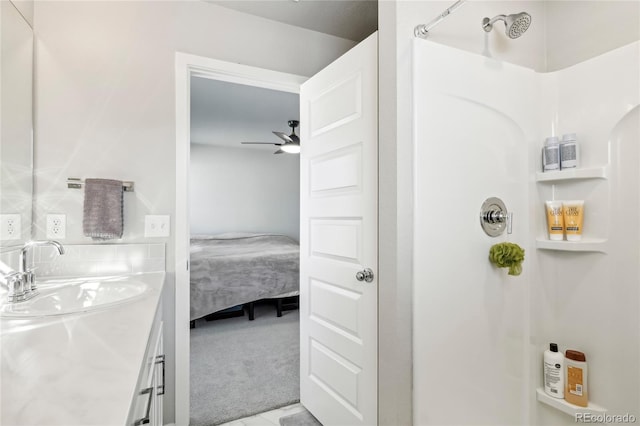 bathroom featuring vanity, ceiling fan, and walk in shower