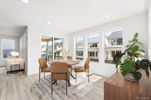 dining area featuring baseboards, light wood finished floors, and recessed lighting