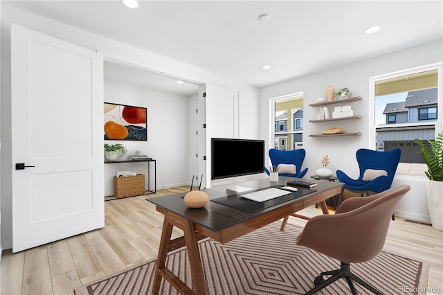 home office with plenty of natural light, light wood-type flooring, and recessed lighting