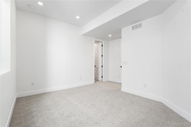 unfurnished room featuring baseboards, recessed lighting, visible vents, and light colored carpet