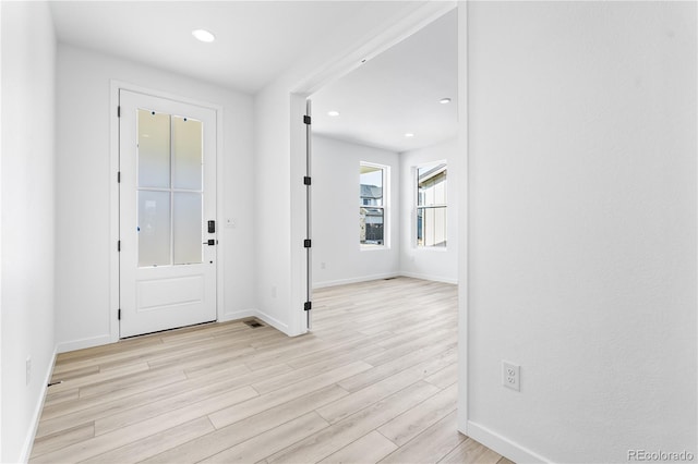 foyer entrance featuring light wood-style floors, recessed lighting, and baseboards