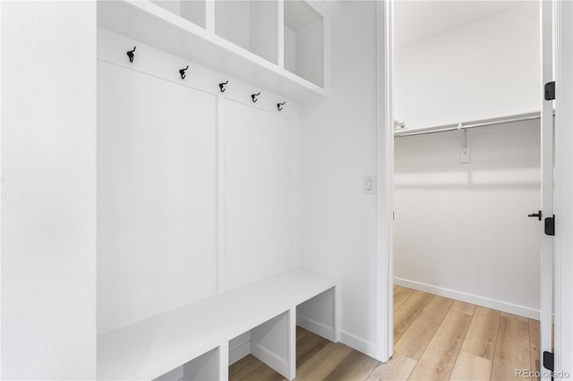 mudroom with light wood-style floors and baseboards