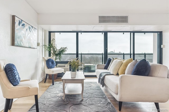 living room featuring visible vents and wood finished floors