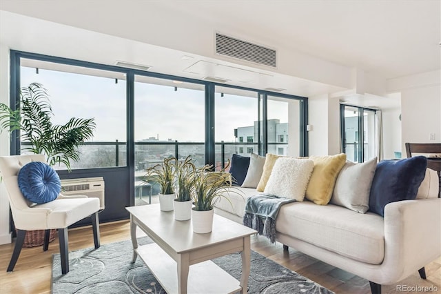 living area with wood finished floors and visible vents