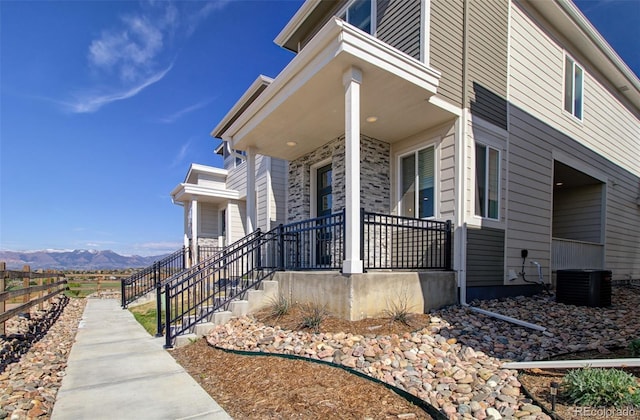 5033 Baseline Vw, Colorado Springs, CO 80920 - view of property exterior with a porch, a mountain view, and central air condition unit