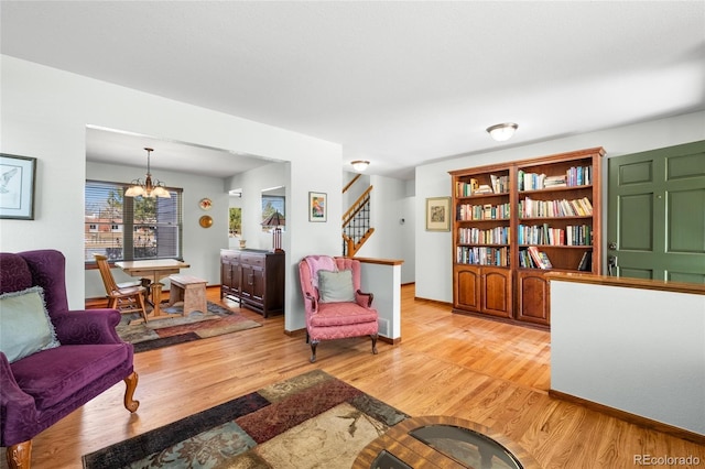 3151 E 134th Cir, Thornton, CO 80241 - living area with stairs, light wood-style floors, and a chandelier