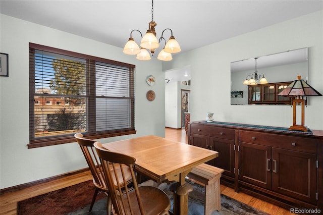 3151 E 134th Cir, Thornton, CO 80241 - dining room featuring a chandelier, wood finished floors, and baseboards